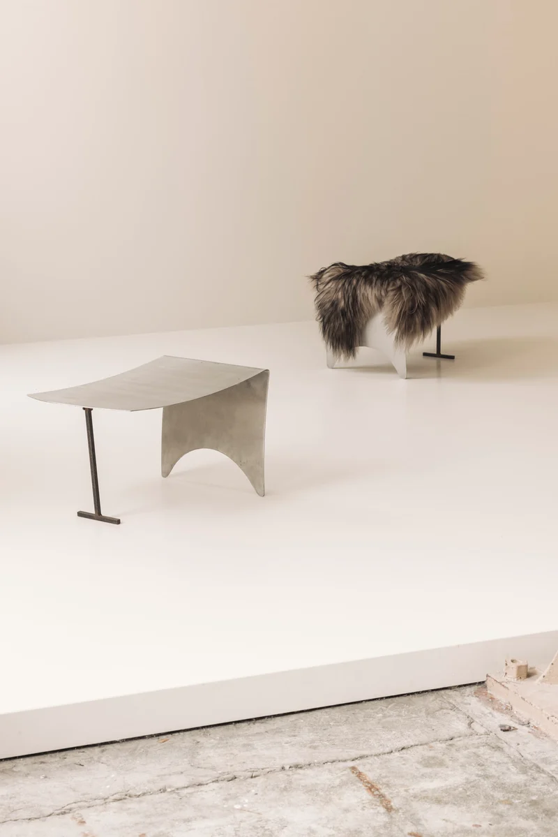 A striking set Modernist curved metal stools from France, dating to the 1980s.