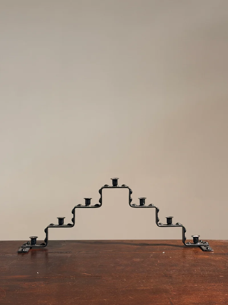 Seven-light geometric candelabra in black iron, circa 1960