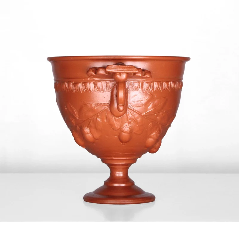 Tasse à vin romain avec reliefs de glands et manche - céramique sigillée