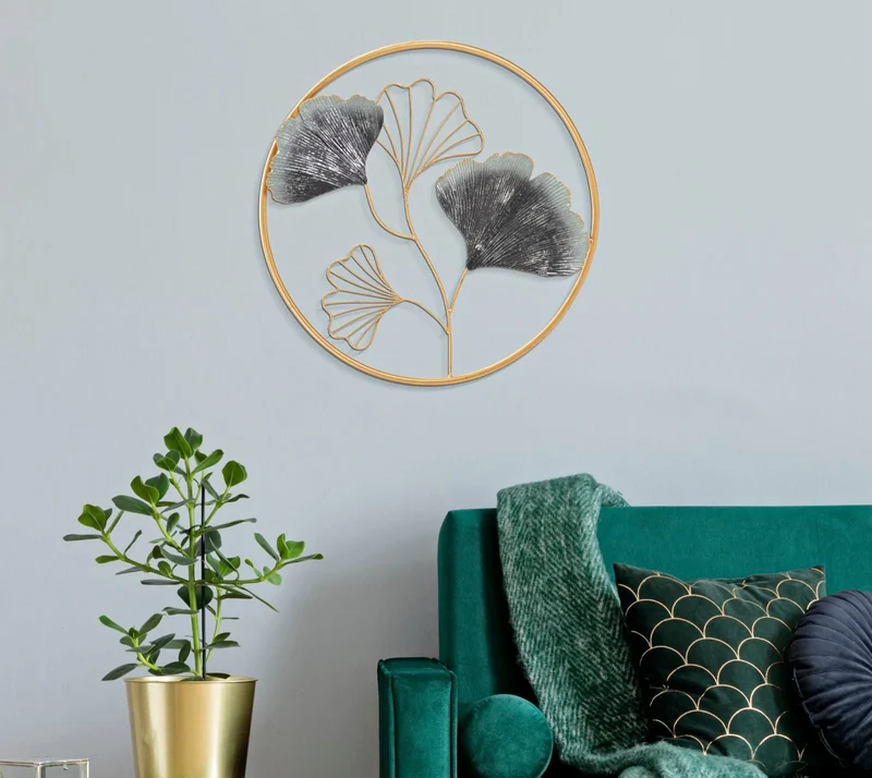 Décoration murale en forme de feuilles métalliques dans un cadre rond