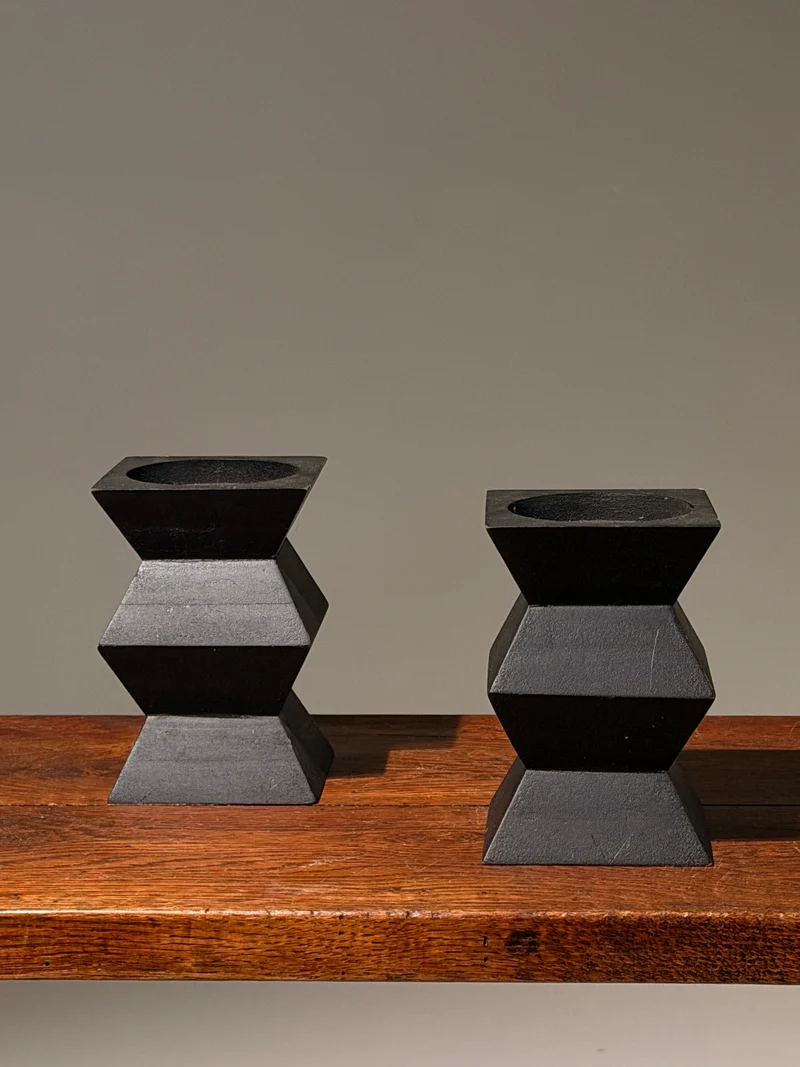 Pair of geometric black wooden candlesticks, anonymous work