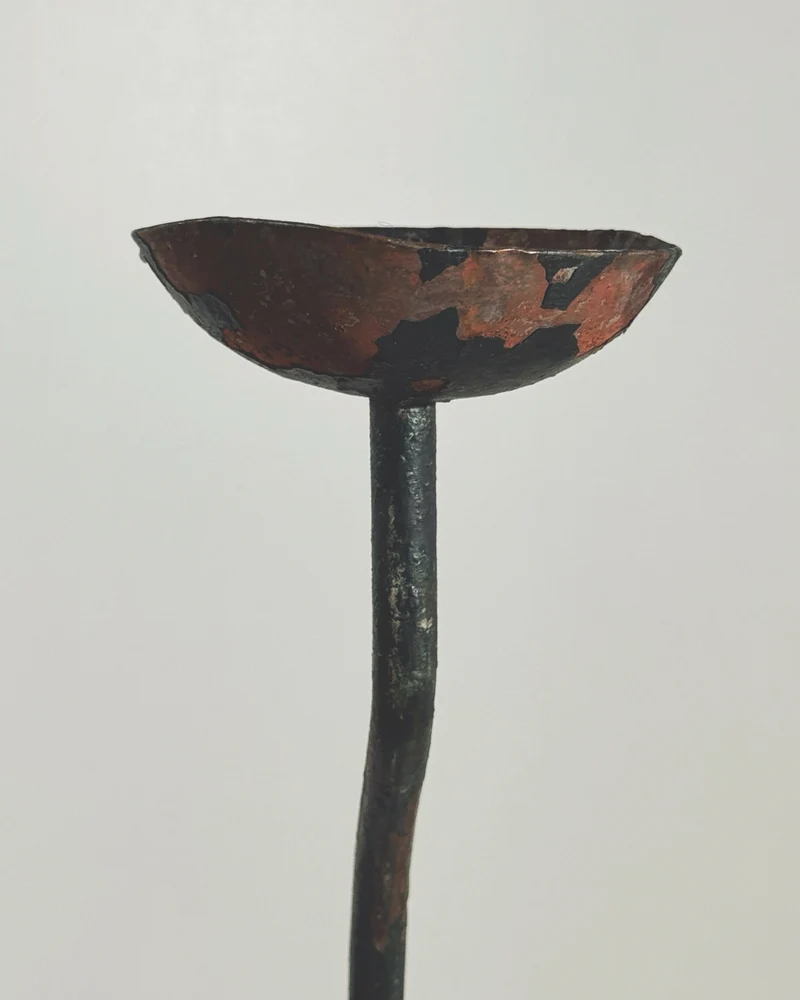 Large sculptural wrought iron candleholder.